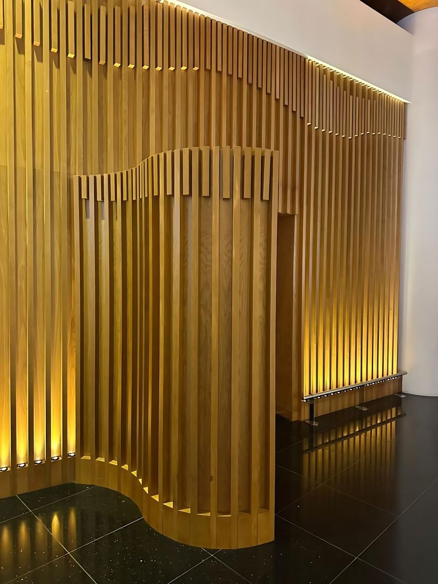 Undulating oak slat wall, lit from below