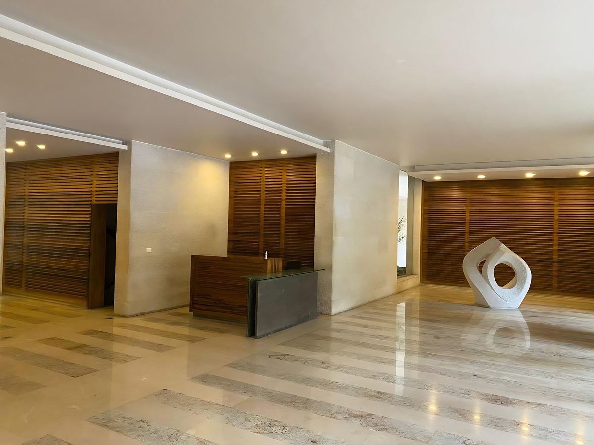 Lobby with walnut slat walls and reception desk