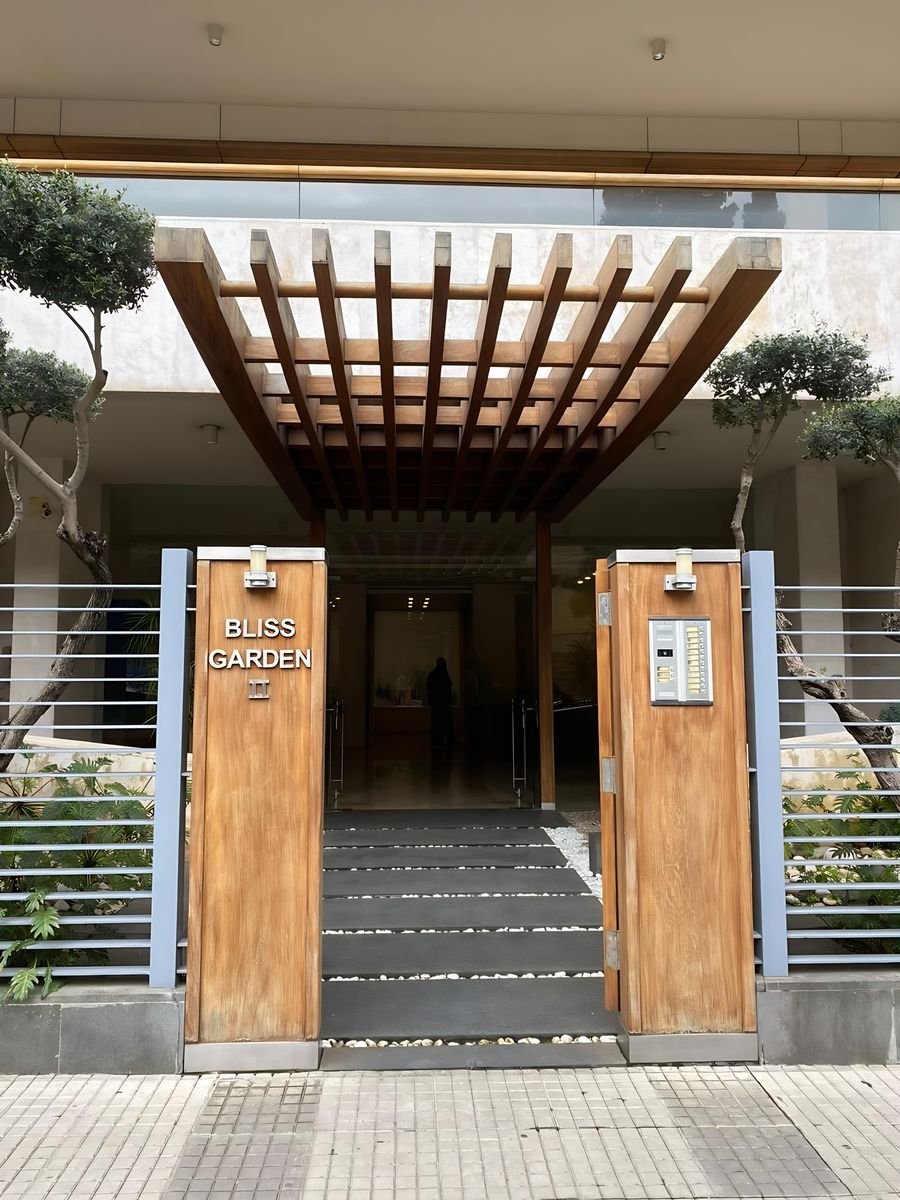 Building entrance with timber pergola and gate panels