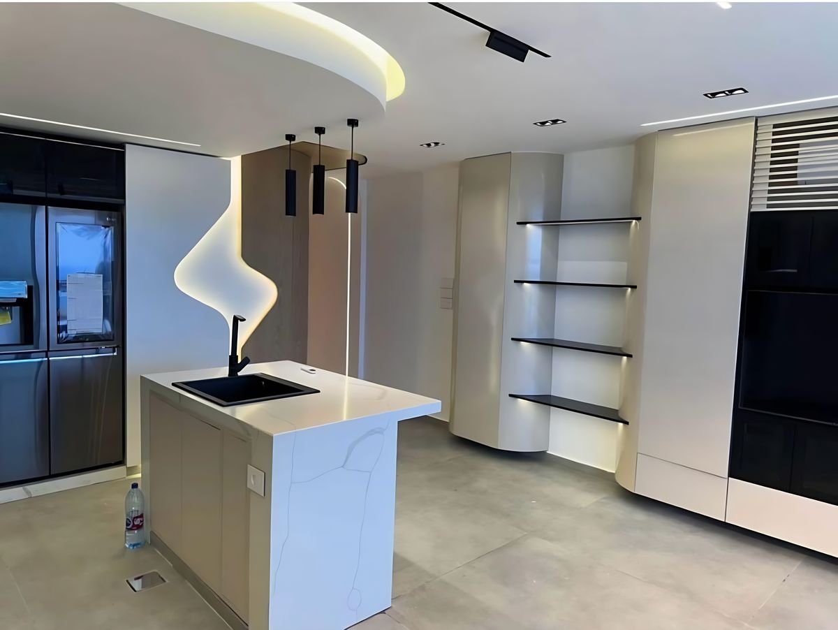 Quartz island, open shelving, tall appliance wall