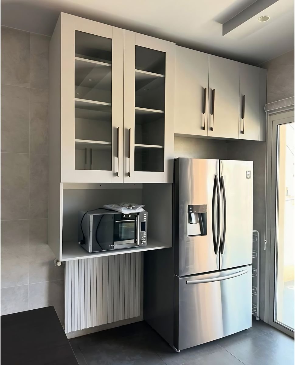 Glass-front wall units and integrated fridge bay
