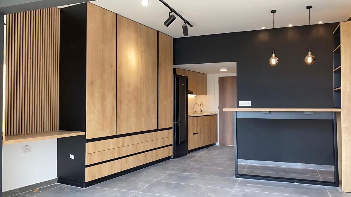 Open-plan studio with an oak storage wall