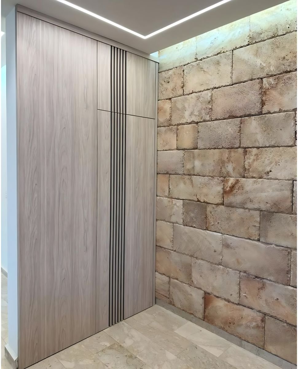 Grey oak wardrobe beside a stone wall